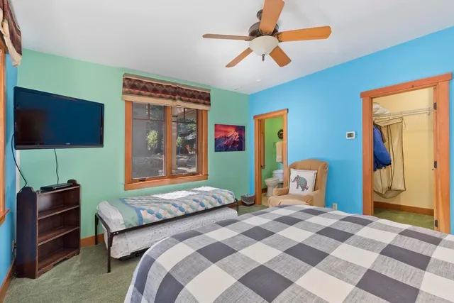 a bedroom with a bed and a flat screen tv