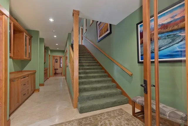 a view of entryway and hall with wooden floor