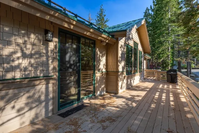 a view of a patio with table and chairs with wooden fence and plants