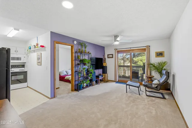 a view of a livingroom with furniture and a window