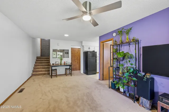 a hallway with furniture and a potted plant