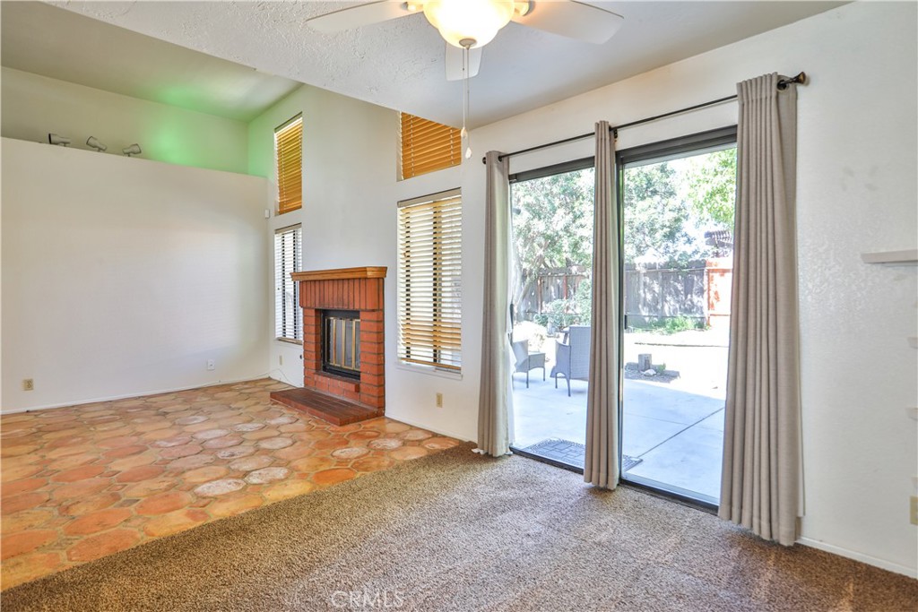 2003 Springcreek Circle Upland, CA 91784 - Photo 11 of 64 a view of an empty room with a fireplace and a window