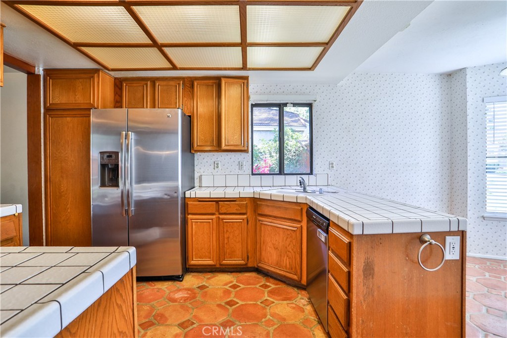 2003 Springcreek Circle Upland, CA 91784 - Photo 14 of 64 a kitchen with stainless steel appliances granite countertop a refrigerator a sink and wooden cabinets