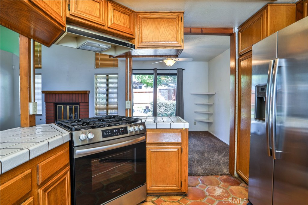 2003 Springcreek Circle Upland, CA 91784 - Photo 16 of 64 a kitchen with stainless steel appliances granite countertop a stove a sink and a refrigerator