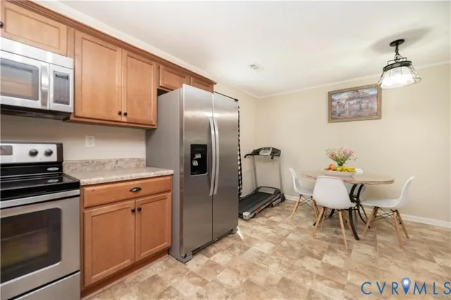 a kitchen with stainless steel appliances granite countertop a stove a sink dishwasher and a refrigerator with wooden cabinets
