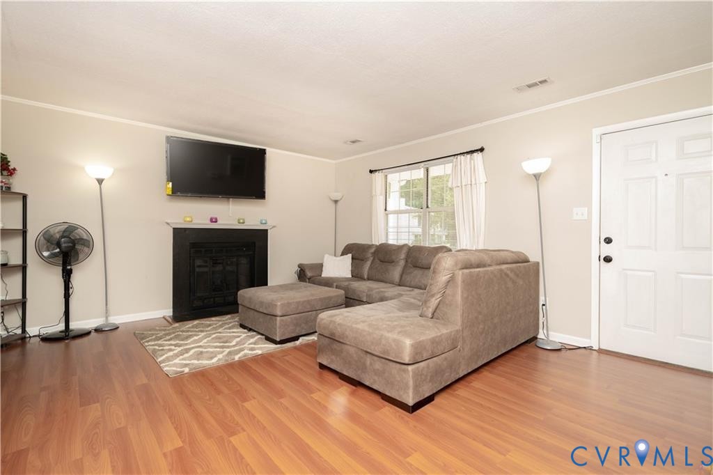9910 Husting Court Chesterfield, VA 23832 - Photo 4 of 19 a living room with furniture a flat screen tv and a fireplace