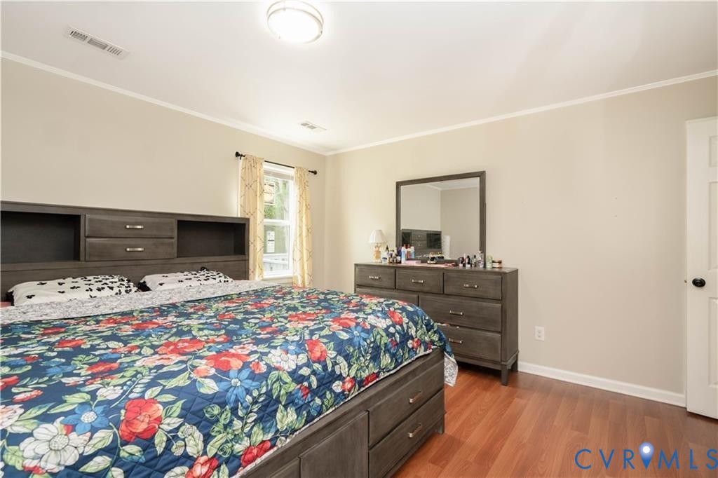 9910 Husting Court Chesterfield, VA 23832 - Photo 6 of 19 a bedroom with a bed and a dresser in it