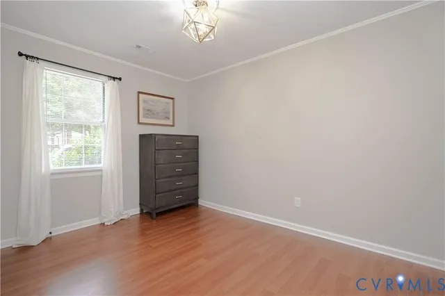 an empty room with cabinet and wooden floor