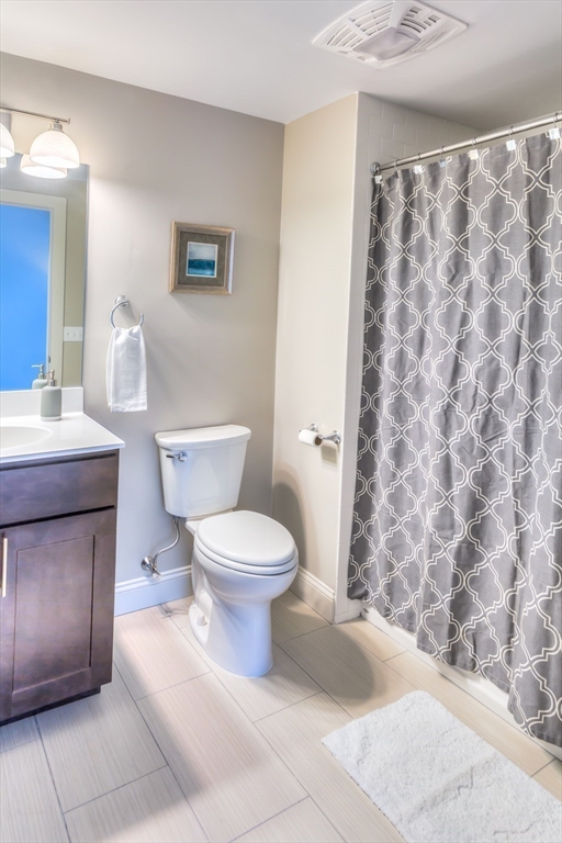 373 Commonwealth Road, Unit 207 Wayland, MA 01778 - Photo 4 of 5 a white toilet sitting next to a bathroom sink