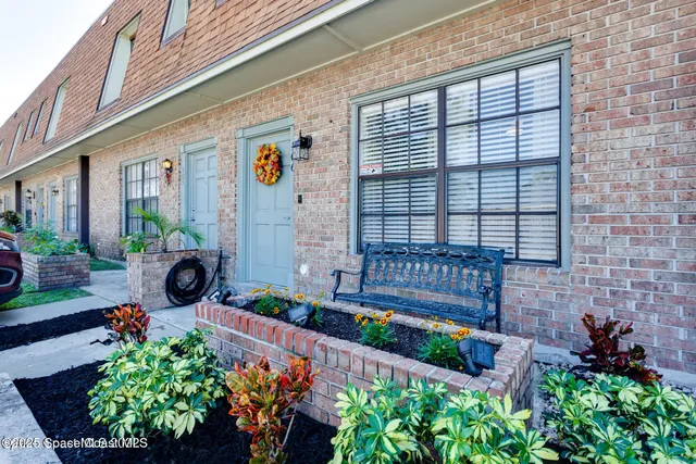 a front view of a house with a yard and fountain