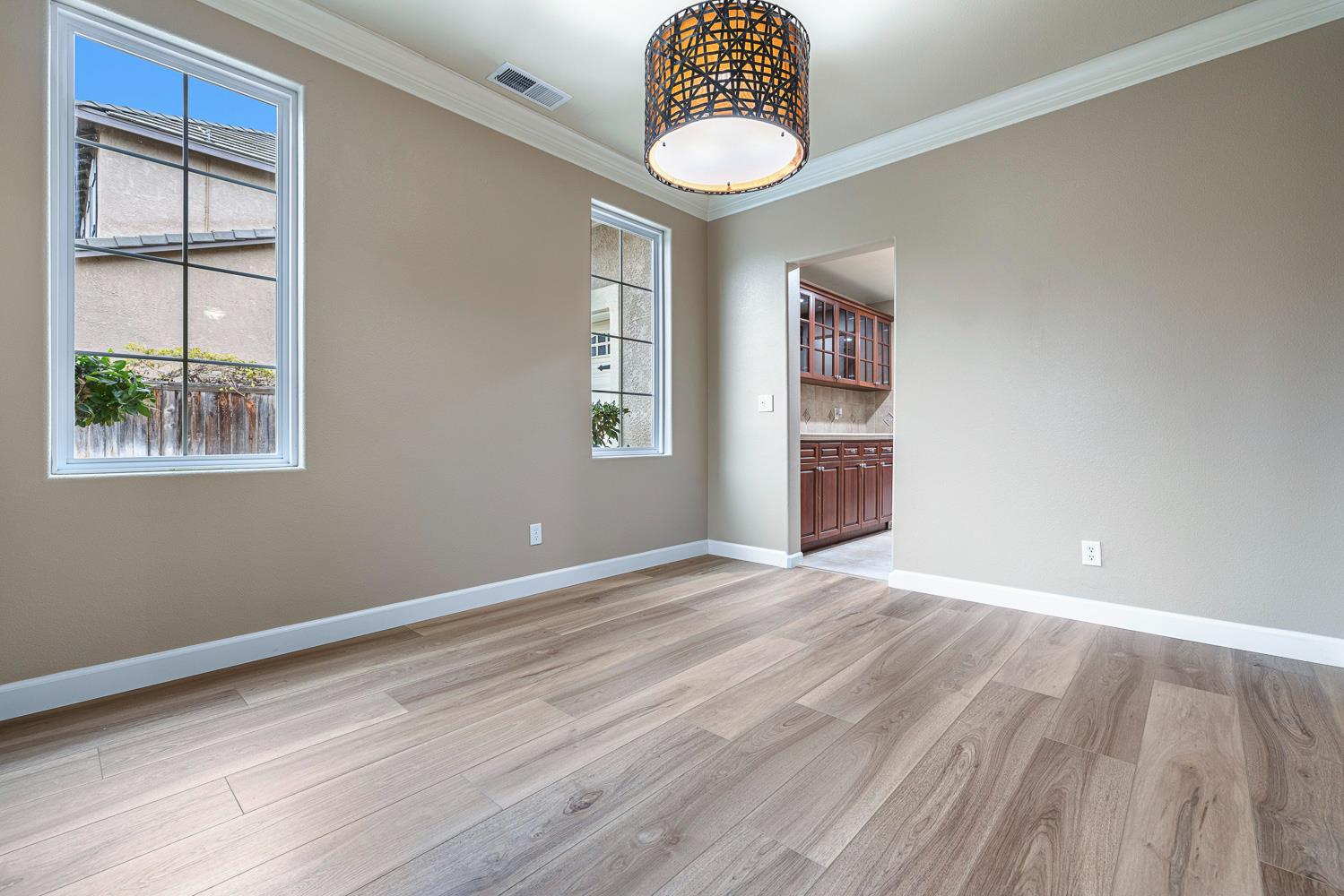 4674 North Arrow Ridge Way Clovis, CA 93619 - Photo 11 of 77 a view of an empty room with a window and wooden floor
