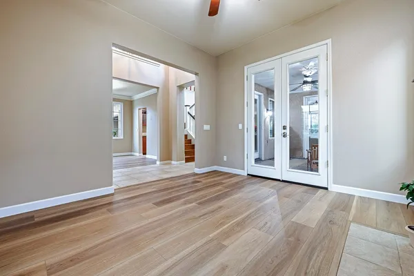 a view of an empty room with a window and fire place
