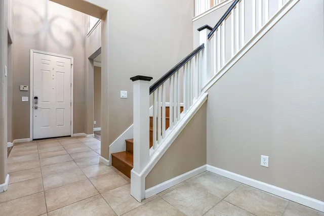 a kitchen with stainless steel appliances granite countertop a sink a stove and a wooden cabinets