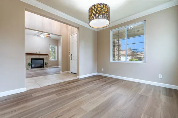 a view of an empty room with a fireplace and window