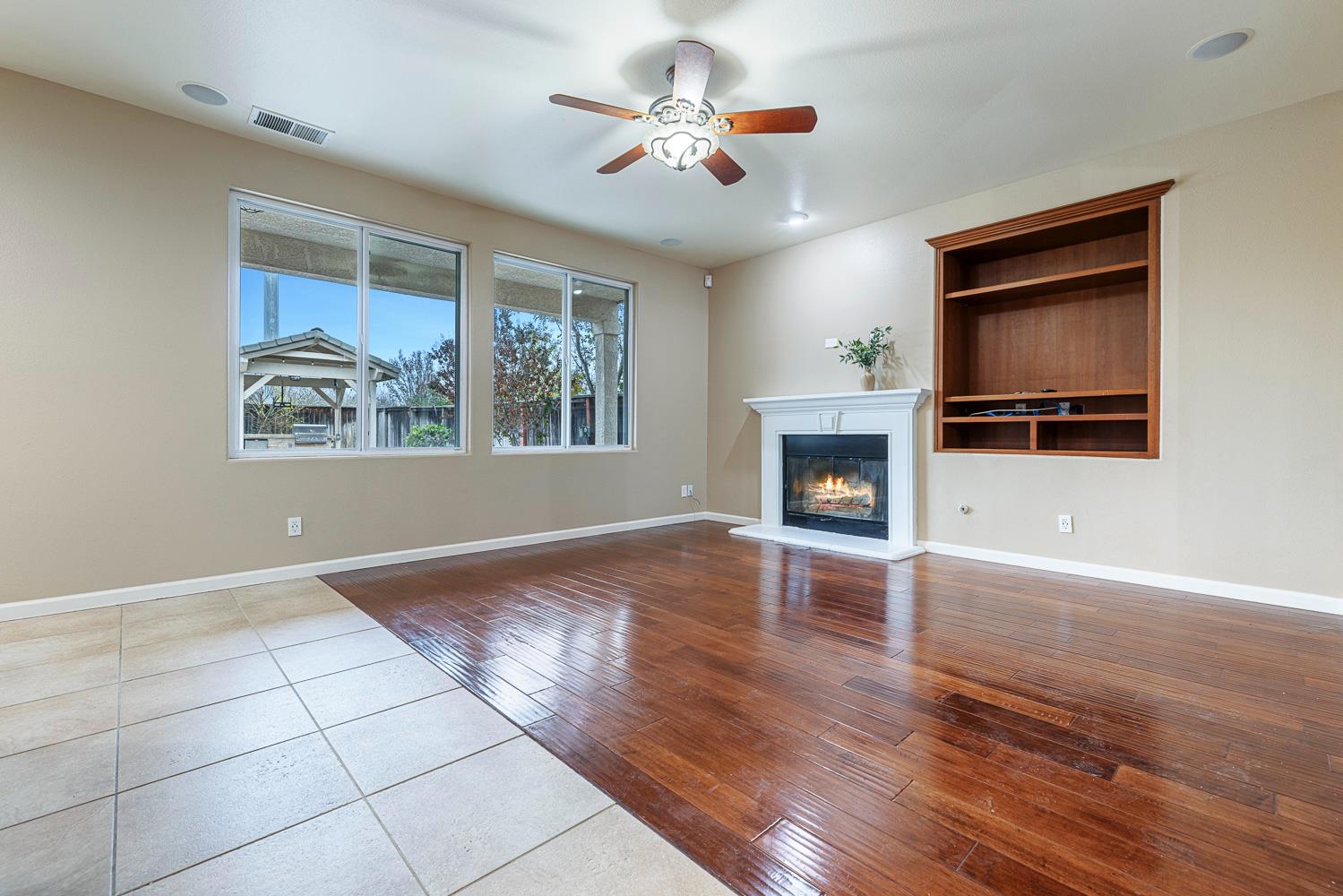 4674 North Arrow Ridge Way Clovis, CA 93619 - Photo 18 of 77 a view of an empty room with a fireplace and window
