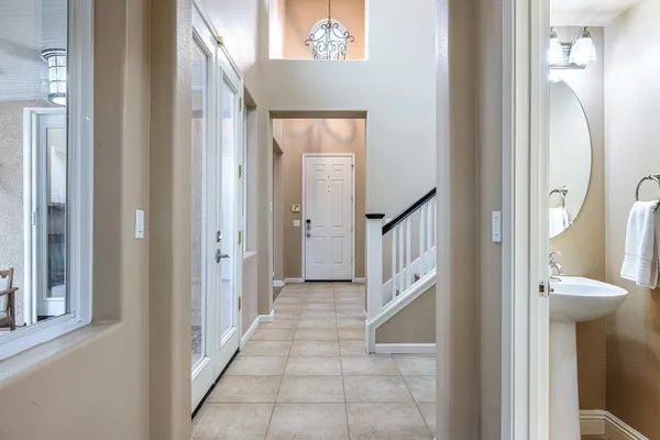 a kitchen with stainless steel appliances granite countertop a sink a stove and a wooden cabinets