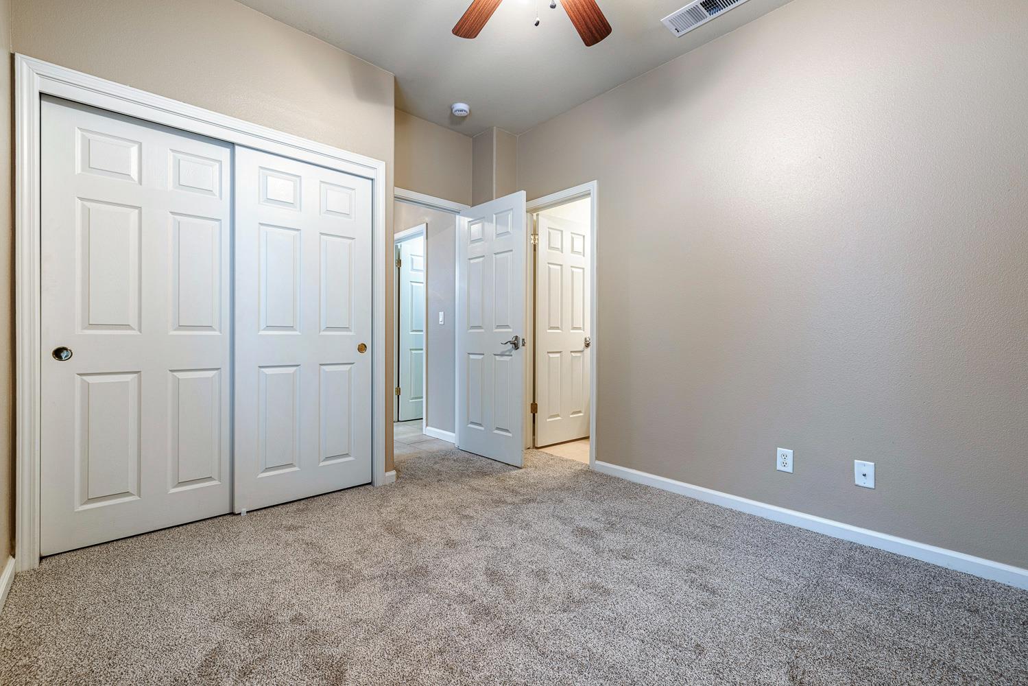 4674 North Arrow Ridge Way Clovis, CA 93619 - Photo 33 of 77 an empty room with closet and chandelier fan