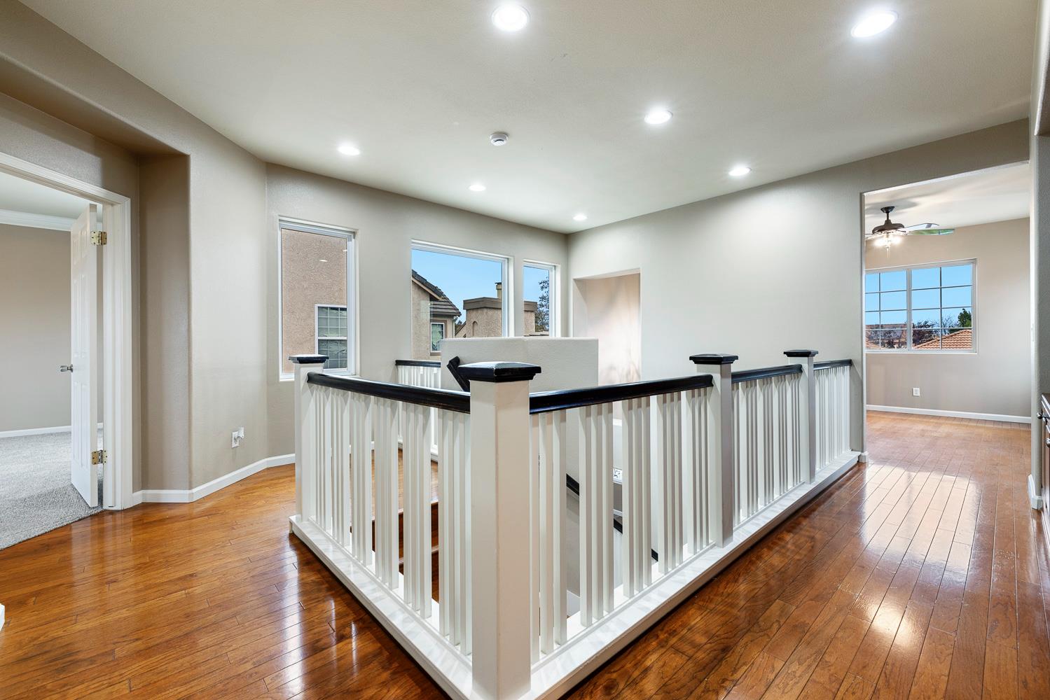 4674 North Arrow Ridge Way Clovis, CA 93619 - Photo 37 of 77 a view of a hallway with wooden floor and staircase