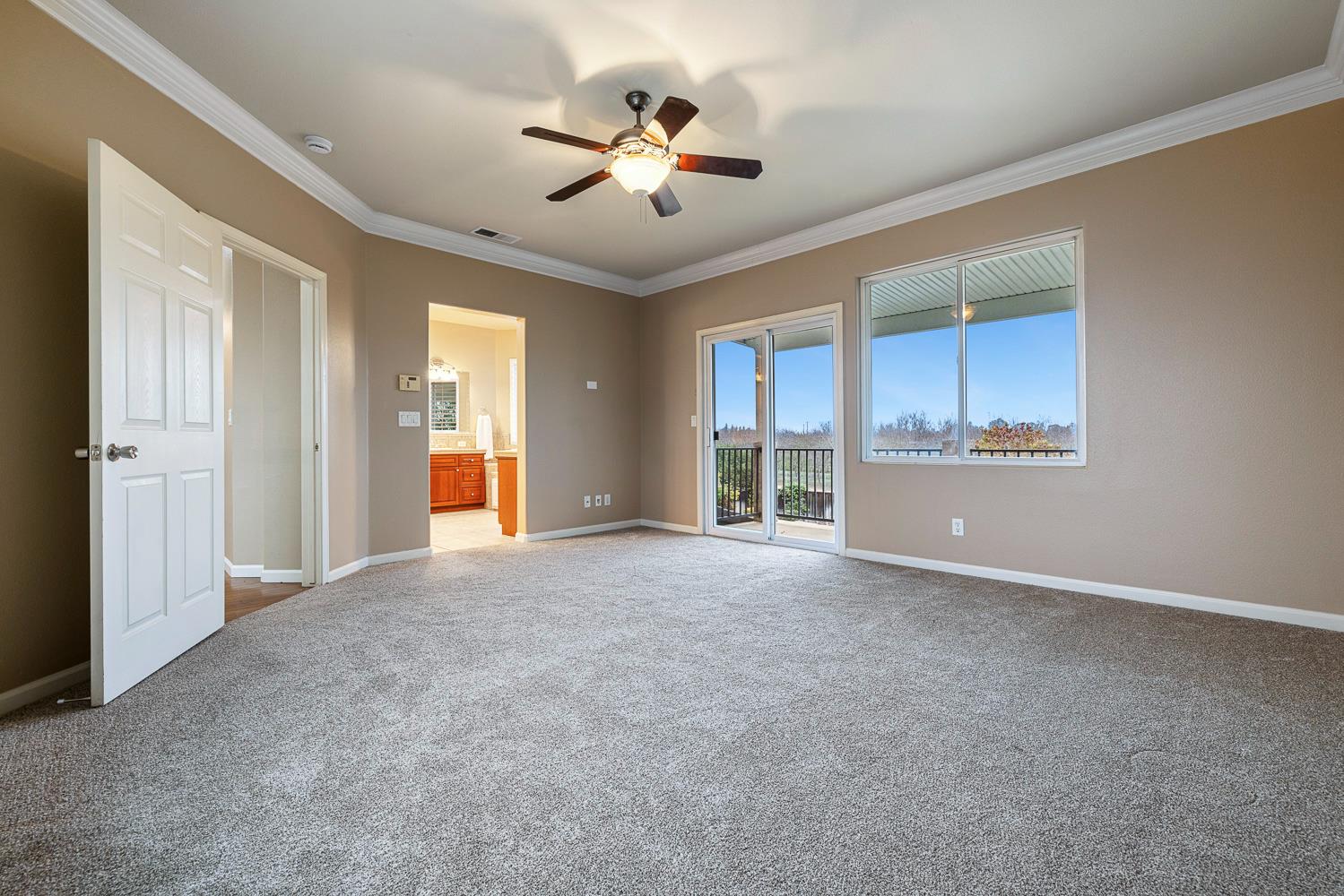 4674 North Arrow Ridge Way Clovis, CA 93619 - Photo 47 of 77 a view of an empty room with chandelier fan and windows