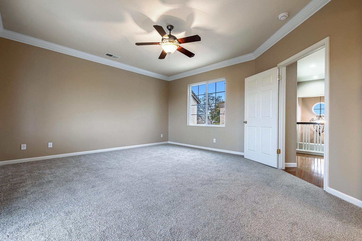 4674 North Arrow Ridge Way Clovis, CA 93619 - Photo 48 of 77 a view of a livingroom with a ceiling fan & windows