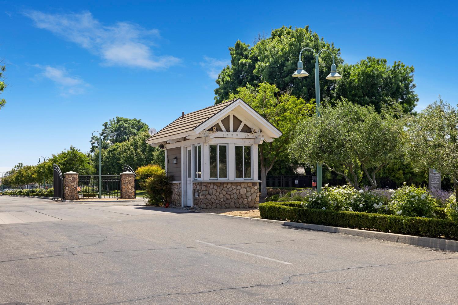 4674 North Arrow Ridge Way Clovis, CA 93619 - Photo 65 of 77 a front view of a house with a garden