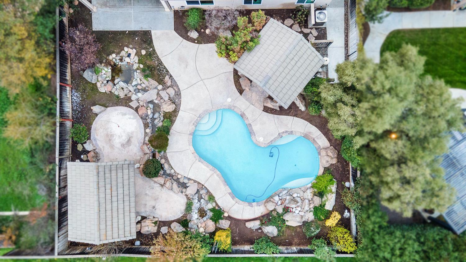 4674 North Arrow Ridge Way Clovis, CA 93619 - Photo 71 of 77 an aerial view of a swimming pool and outdoor space