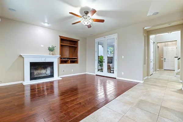 an empty room that has a window and mirror