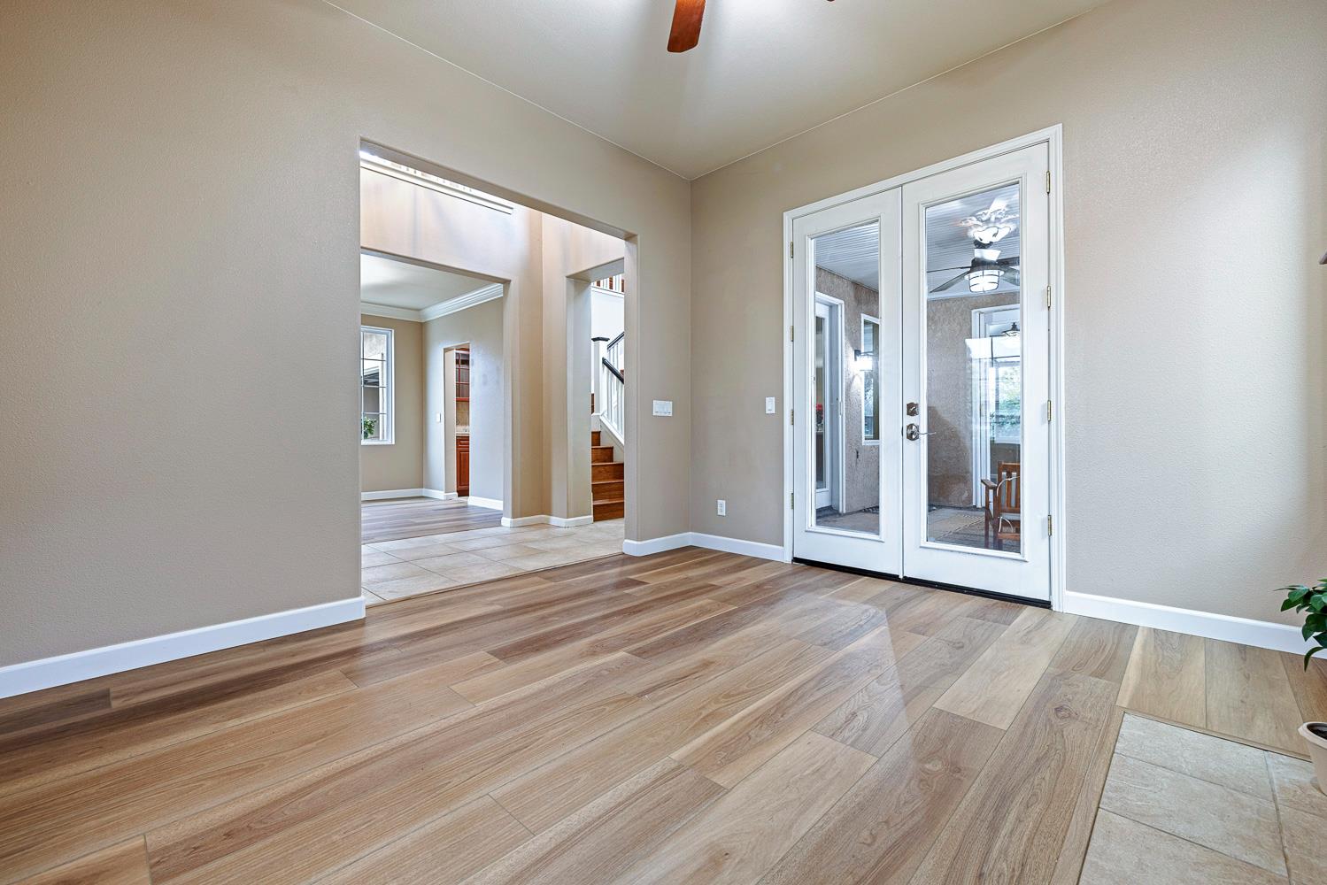 4674 North Arrow Ridge Way Clovis, CA 93619 - Photo 10 of 77 a view of an empty room with wooden floor and a window