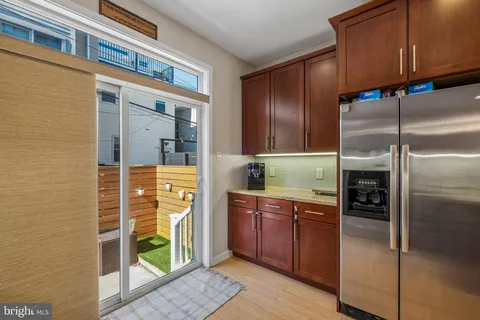 a bedroom with a bed and a flat tv screen next to a window