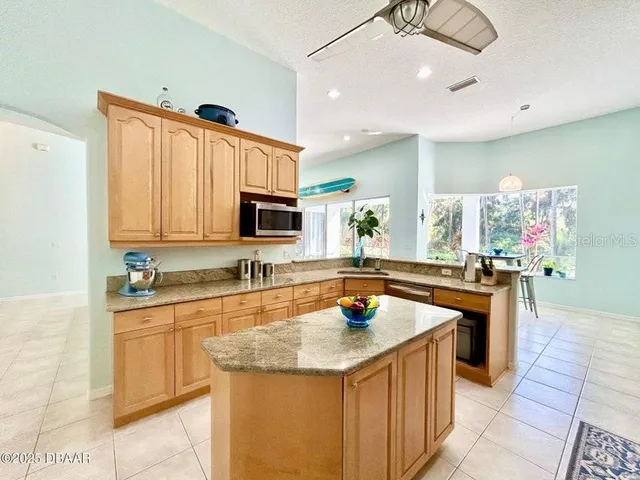 a kitchen with stainless steel appliances granite countertop a stove and a refrigerator
