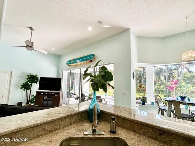 a view of a dining room with furniture a chandelier and wooden floor