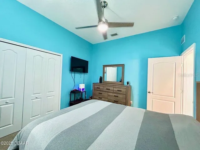 a front view of a house with a yard and potted plants