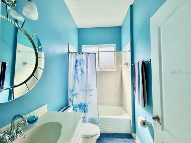 a front view of house with yard and trees around