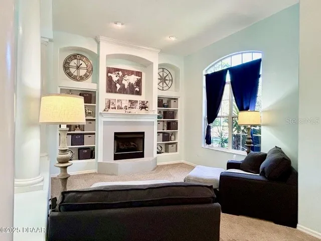 a living room with furniture a clock and a fireplace