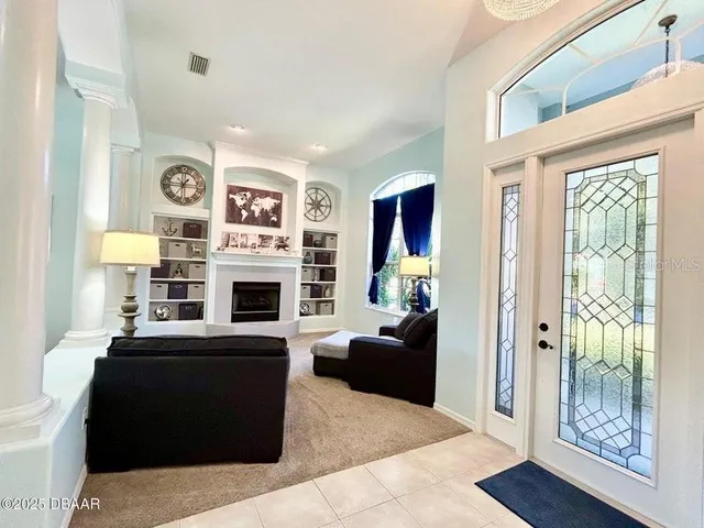 a living room with furniture and a fireplace