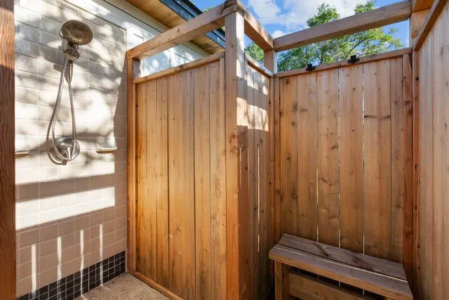 a view of a house with backyard and wooden fence