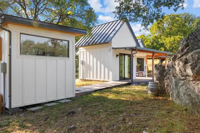 a view of a house with backyard and sitting area