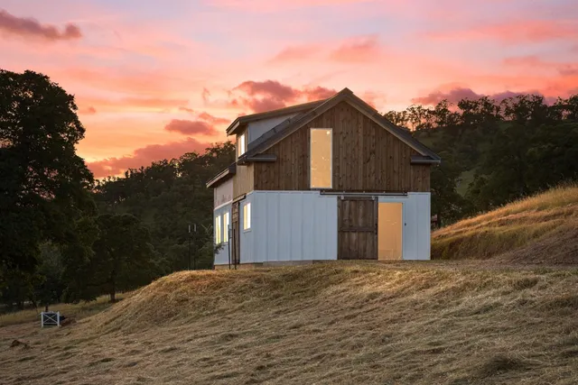 a view of a house with truck parked on the road