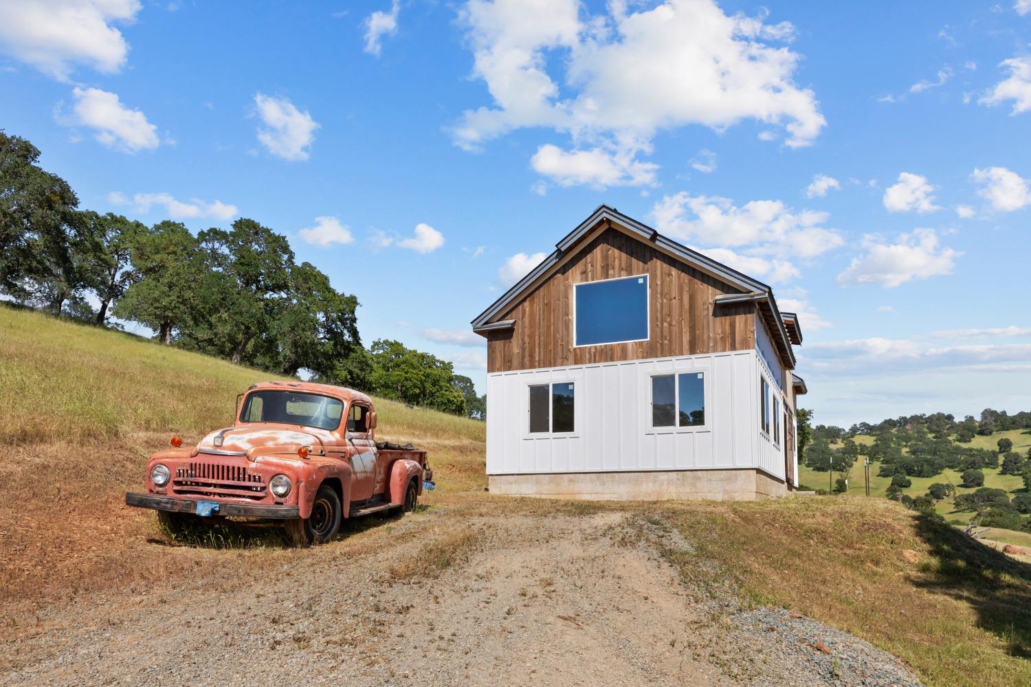 14883 Vaira Ranch Road Drytown, CA 95699 - Photo 29 of 60 a view of a house with truck parked on the road