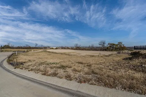 a view of a lake with houses in the back