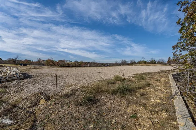 a view of a dry yard with a barn