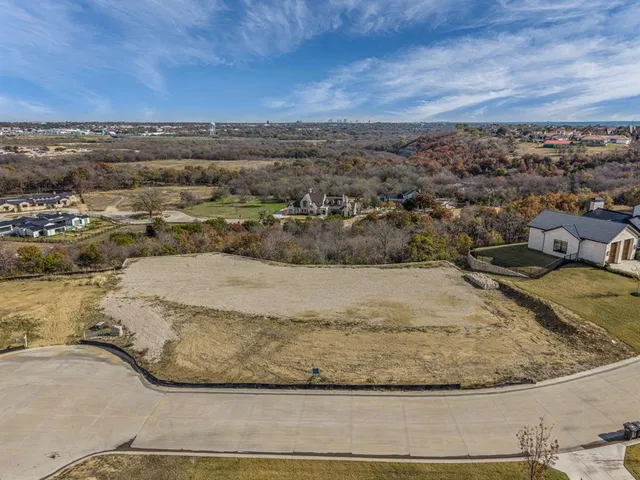 a view of a yard with wooden floor and city view