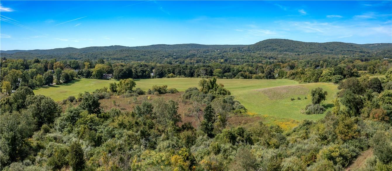 57 Quaker Hill Road Pawling, NY 12564 - Photo 16 of 20 a view of a lush green hillside and a building