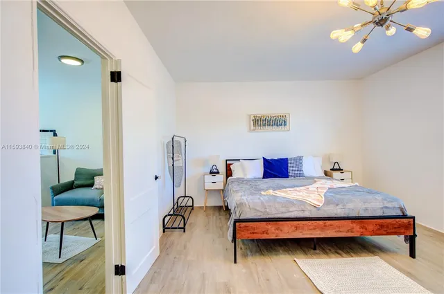 a kitchen with a stove and a wooden floor