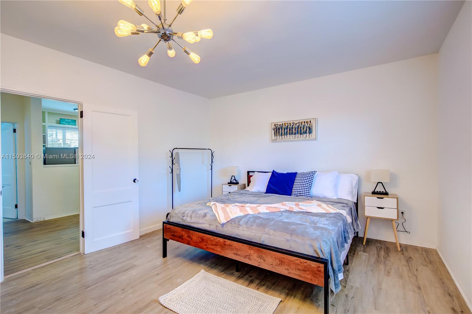 855 Southwest 7th Street Miami, FL 33130 - Photo 35 of 59 a bedroom with a bed and a chandelier