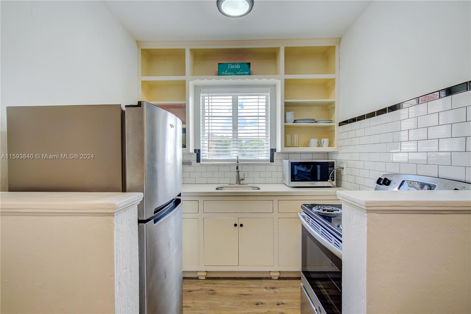 855 Southwest 7th Street Miami, FL 33130 - Photo 39 of 59 a kitchen with a sink a refrigerator and cabinets