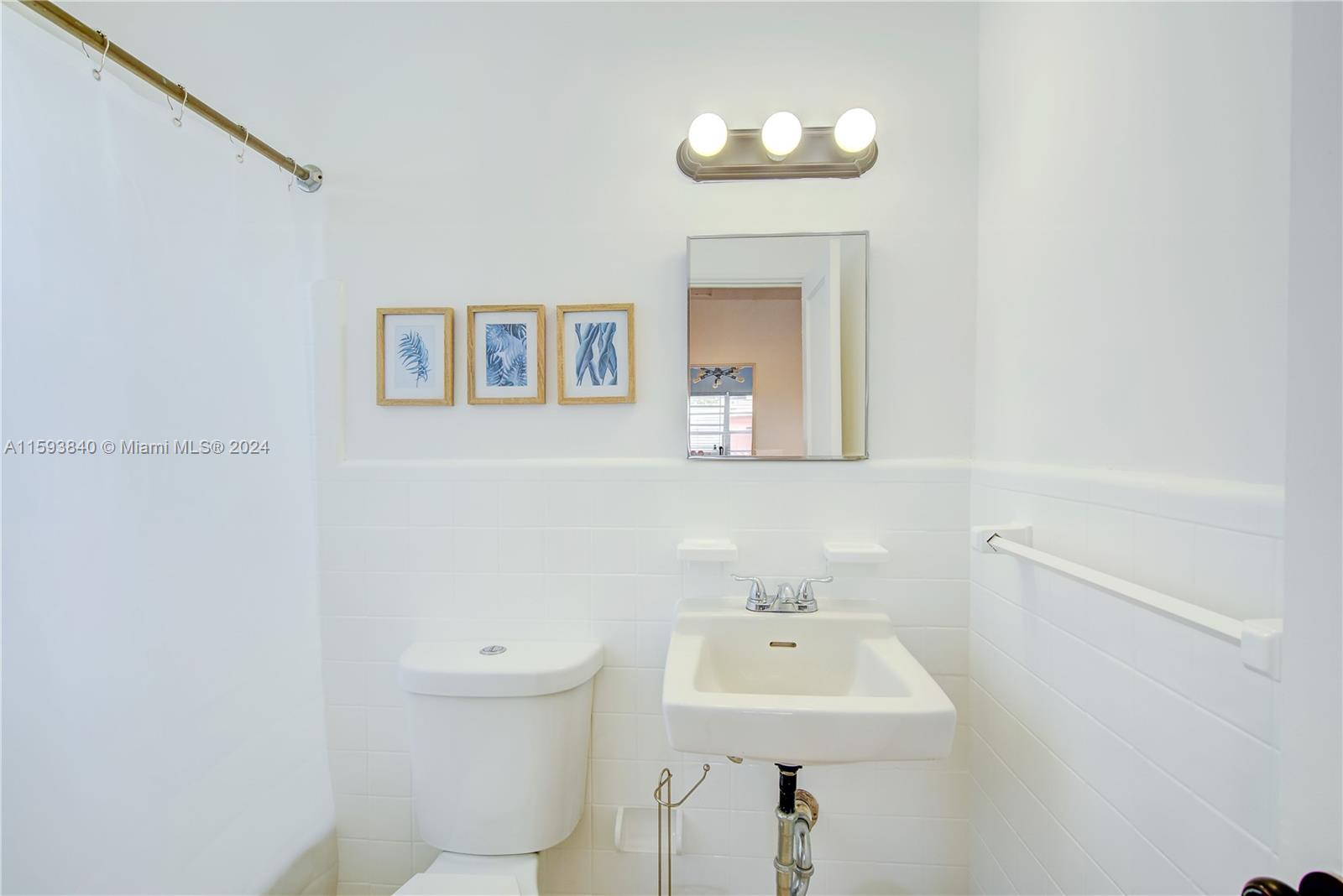 855 Southwest 7th Street Miami, FL 33130 - Photo 42 of 59 a bathroom with a sink a toilet and mirror