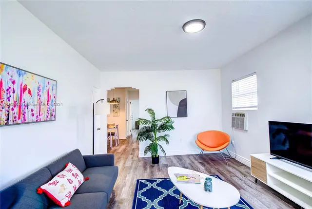 a living room with furniture potted plant and a lamp