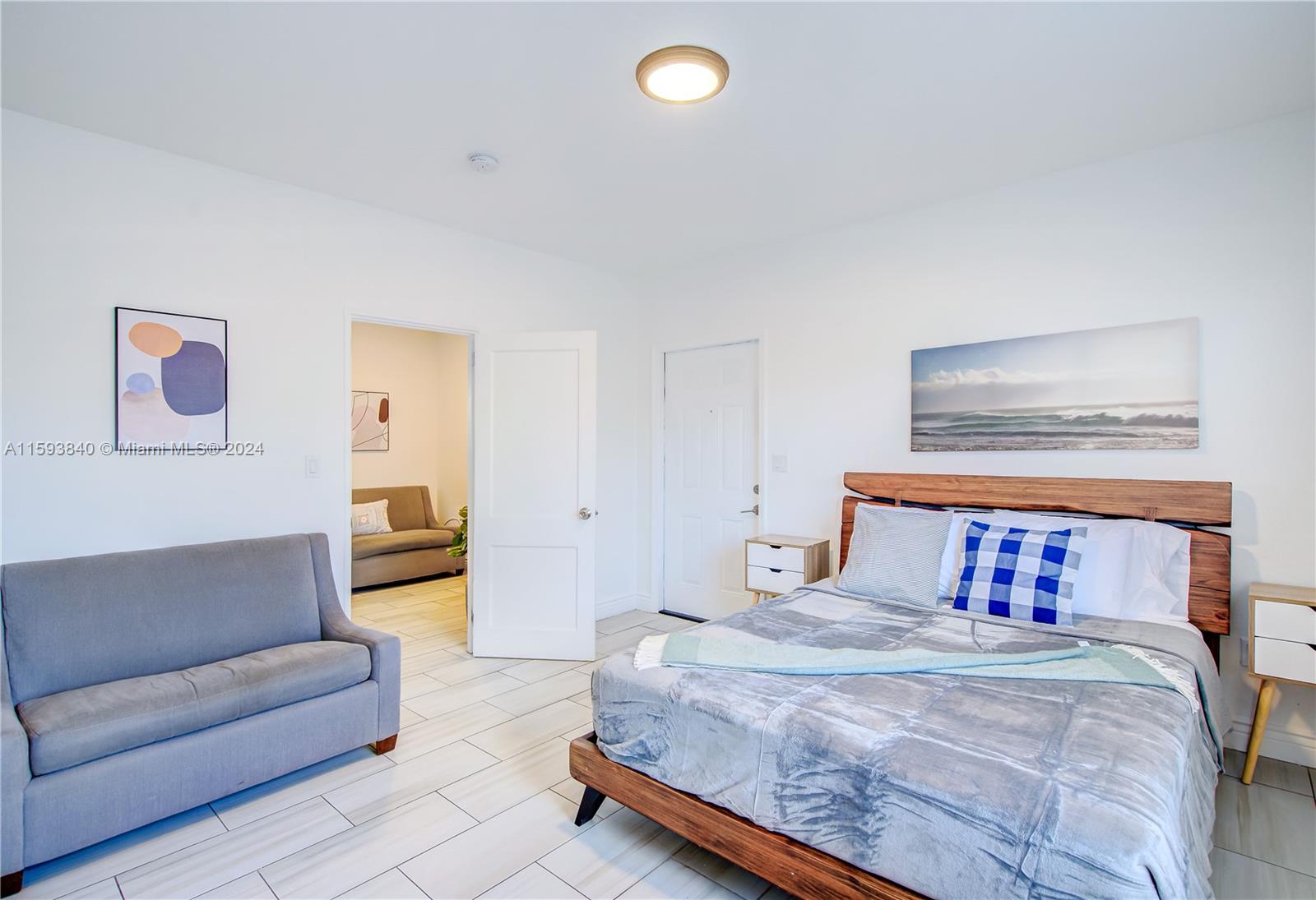 855 Southwest 7th Street Miami, FL 33130 - Photo 58 of 59 a bedroom with a large bed and a couch