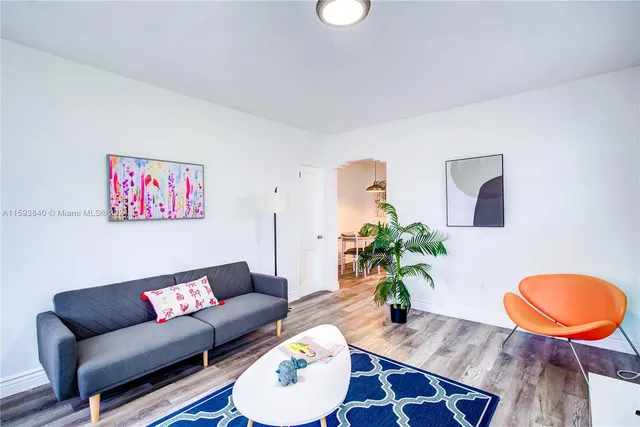 a kitchen with stainless steel appliances a refrigerator a sink a stove a faucet a potted plant a counter top space and cabinets